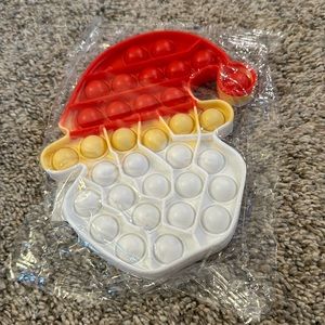 Santa  pop it for kids.  Red and white in color.  Perfect gift for stockings